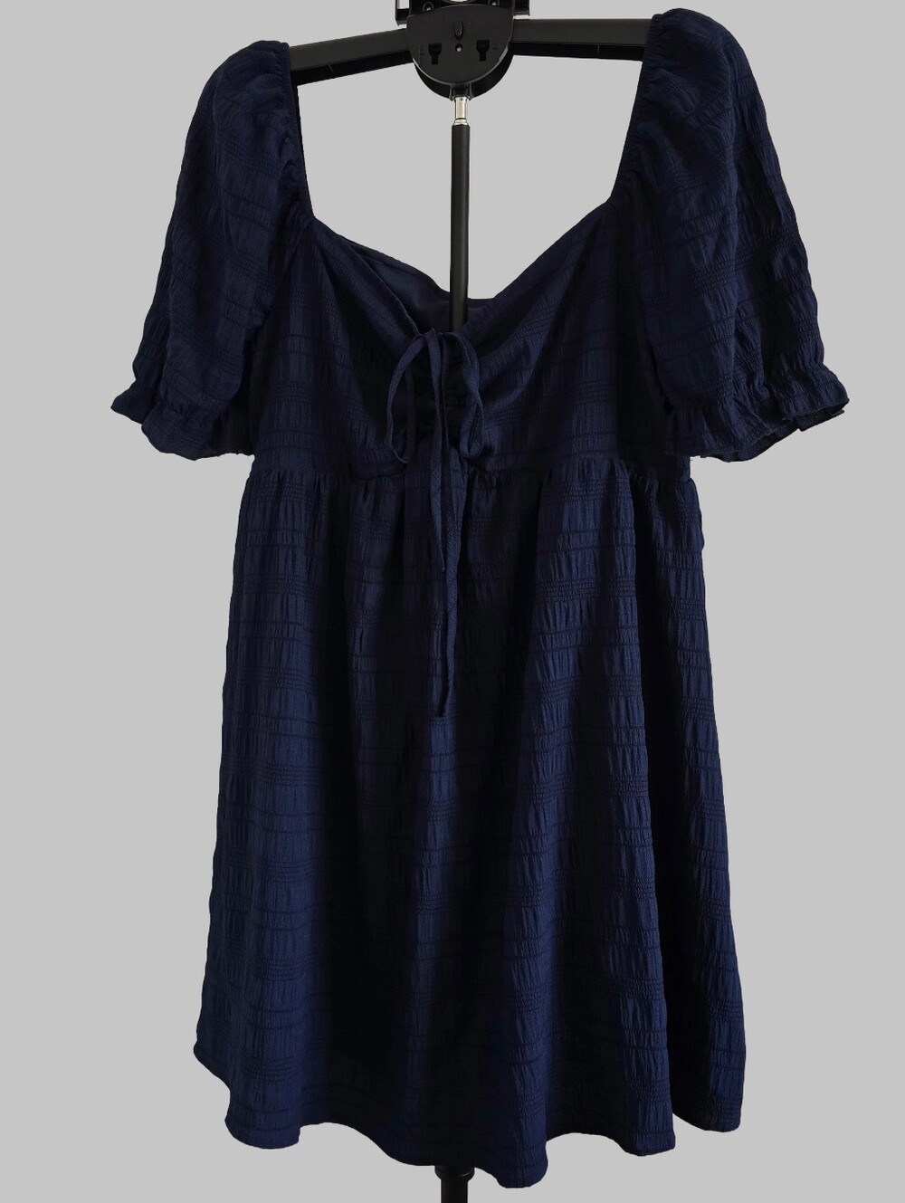 Navy blue mini/babydoll-style dress featuring a textured, crinkled woven fabic